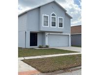 Two-story home with attached garage, neutral paint and manicured lawn provides great curb appeal at 11102 Summer Star Dr, Riverview, FL 33579