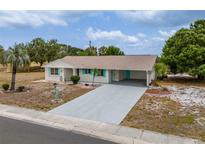 Charming single-story home featuring a long driveway and carport at 1509 Cherry Hills Dr, Sun City Center, FL 33573