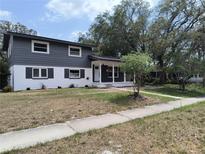 Charming two-story home featuring a freshly painted exterior and well-maintained front yard at 1907 E 111Th Ave, Tampa, FL 33612