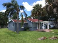 Charming single-story home with a red roof, mature landscaping, and inviting front porch at 3007 Clinton S St, Gulfport, FL 33707