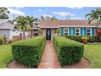 Charming home with a manicured lawn, walkway, black door, and vibrant blue shutters providing a welcoming entrance at 3800 6Th N Ave, St Petersburg, FL 33713