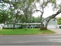 Charming single-Gathering home with mature trees and lush green lawn on a quiet street at 888 Forest Glen Rd, Clearwater, FL 33765