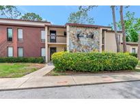 Charming condo with stone facade and well-maintained landscaping at 1200 Tarpon Woods Blvd # M8, Palm Harbor, FL 34685