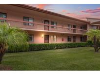 Charming condo building with well-manicured lawn and mature tropical landscaping creating curb appeal at 143 Lakeside Dr # 143, Oldsmar, FL 34677
