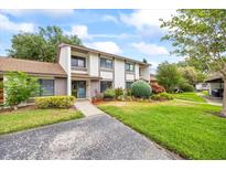 Charming two-story home with landscaped yard and inviting front entrance at 1815 Cypress Trace Dr, Safety Harbor, FL 34695