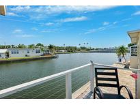 Scenic waterfront view from the deck, showcasing serene water, lush vegetation, and clear blue skies at 18675 Us Highway 19 N # 261, Clearwater, FL 33764