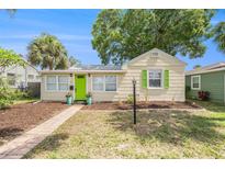 Charming single-story home featuring a vibrant green door and well-maintained front yard at 2627 8Th N Ave, St Petersburg, FL 33713