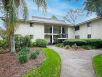 Beautiful two-story condo with a metal roof and lush landscaping surrounding the building at 29147 Bay Hollow Dr # 3217, Wesley Chapel, FL 33543
