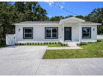 Charming single-story home with a freshly painted exterior and meticulously manicured landscaping at 3016 N 73Rd St, Tampa, FL 33619