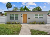 Charming home with a modern front door, well-maintained lawn, and lush landscaping at 3151 6Th S Ave, St Petersburg, FL 33712