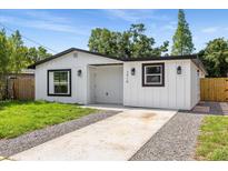Charming single-story home features white siding, modern windows, and a well-manicured lawn at 3910 W Iowa Ave, Tampa, FL 33616
