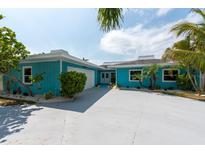 Beautifully landscaped single-story home with a blue exterior and a spacious driveway at 4643 Bay Crest Dr, Tampa, FL 33615