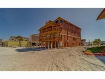 Coastal three-story home featuring multiple balconies and beach access at 17606 Lee Ave, Redington Shores, FL 33708