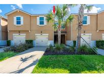 Charming townhome featuring a well-maintained lawn and appealing exterior at 17847 Althea Blue Pl, Lutz, FL 33558