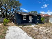 Charming one-story home featuring a quaint porch and a driveway, set under a bright, sunny sky at 1931 44Th S St, St Petersburg, FL 33711