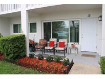 Charming front porch features colorful plants, comfortable seating, and a welcoming entrance at 2020 World Parkway Blvd # 12, Clearwater, FL 33763