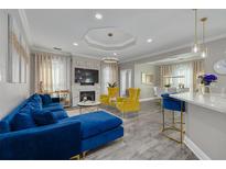 Bright living room featuring a fireplace, hardwood floors, and stylish, colorful furniture at 2722 Via Tivoli # 430A, Clearwater, FL 33764