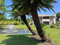 Charming two-story villa with lush landscaping and a serene pond view with fountain at 2969 Bonaventure Cir # 104, Palm Harbor, FL 34684