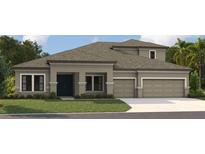 Charming single-Gathering home featuring a two-car garage, craftsman-style windows, and a well-manicured lawn at 5144 Wildwind Dr, Apollo Beach, FL 33572