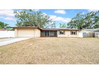 Charming single-story home featuring brick accents, a well-maintained lawn, and an attached garage at 812 Regent Circle S, Brandon, FL 33511