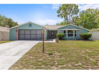 Charming single-story home with a well-maintained lawn and attached garage, offering great curb appeal at 10512 Red Coach St, Spring Hill, FL 34608