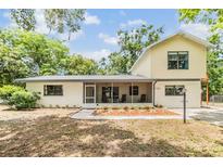 Charming two-story home with landscaped yard and a cozy screened-in porch, perfect for relaxing outdoors at 1225 15Th St, Palm Harbor, FL 34683