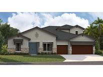 Charming home featuring a blue front door, stone accents and a two-car garage at 12828 Daleridge Pl, Riverview, FL 33579