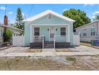 Charming bungalow with light blue exterior, white trim, and inviting front porch at 2306 W Ivy St, Tampa, FL 33607