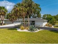 Charming single-story home showcasing a well-manicured front yard and stylish landscaping at 3236 San Pedro St, Clearwater, FL 33759