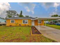 Charming single-story home with a well-maintained lawn and a covered carport at 404 12Th Sw St, Ruskin, FL 33570