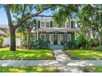 Charming two-story home with mature trees, manicured lawn, and inviting front porch at 516 14Th Ne Ave, St Petersburg, FL 33701