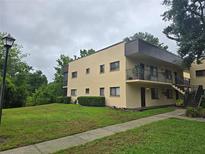 Inviting two-story condo building featuring well-maintained landscaping and convenient stairway access to upper levels at 11802 Raintree Lake Ln # B, Temple Terrace, FL 33617