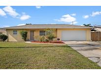 Charming single-story home with a well-manicured lawn and an attached two-car garage at 1226 Hermitage Ave, Clearwater, FL 33764