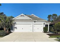 Charming home featuring a two-car garage, landscaped yard, and a well-maintained exterior at 1600 Still River Dr, Venice, FL 34293