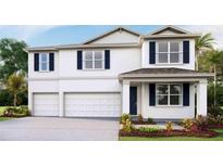 Charming two-story home featuring a two-car garage, well-maintained landscaping and inviting entryway at 2245 Sienna Spruce St, Wesley Chapel, FL 33543