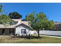 Charming home featuring a white brick facade, mature landscaping, and a well-maintained lawn at 3403 Jamais Wood Way, Tampa, FL 33618