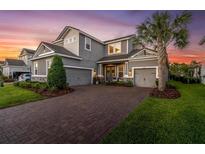Charming two-story home with a three-car garage and a well-manicured lawn at 3850 Bonfire Dr, Odessa, FL 33556