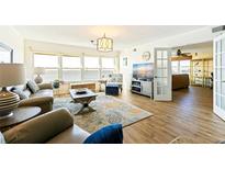Bright living room with hardwood floors, water view, and stylish furnishings at 5900 Shore S Blvd # 512, Gulfport, FL 33707