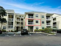 Inviting condo building with accessible parking and well-maintained landscaping, featuring a private balcony for outdoor enjoyment at 6931 Stones Throw N Cir # 5210, St Petersburg, FL 33710