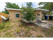 View of the backyard patio with mature landscaping, providing a relaxing outdoor space at 1144 7Th Nw St, Largo, FL 33770