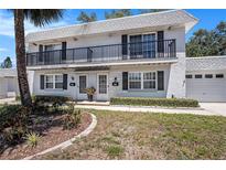 Charming condo with a balcony, manicured lawn, and a one-car garage in a tranquil neighborhood at 202 Mindy Dr, Largo, FL 33771
