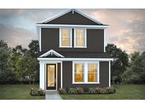 Charming two-story home featuring dark brown siding and white trim, surrounded by a green lawn and trees at 2043 Wild Heron Ct, Valrico, FL 33596
