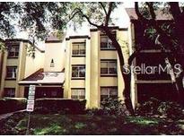 Charming building featuring a prominent turret-like element with large windows and mature trees in a tranquil setting at 4411 Shady Terrace Ln # 308, Tampa, FL 33613