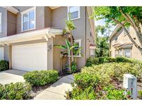 Charming townhome featuring a one car garage and lush landscaping at 4968 Anniston Cir, Tampa, FL 33647