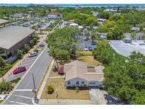 An aerial view showcases this cozy residence nestled in a vibrant neighborhood close to local amenities and waterfront views at 556 Virginia St, Dunedin, FL 34698