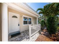 Inviting entryway featuring a white front door, decorative railing, and well-maintained landscaping at 5785 15Th N Ave, St Petersburg, FL 33710