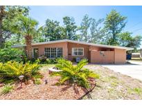 Charming single-story home boasting lush landscaping and mature trees, creating a welcoming curb appeal at 7401 11Th N Ave, St Petersburg, FL 33710