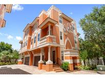 A bright, multi-story home featuring balconies, columns, and a two-car garage at 904 Villa Venicia Way, Tampa, FL 33606