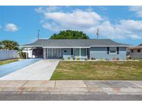 Charming single-story home with a carport, well-manicured lawn, and lovely landscaping at 906 Hacienda Dr, Sun City Center, FL 33573