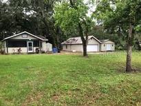 Charming single-story home with a well-maintained lawn and a detached garage at 118 W 122Nd Ave, Tampa, FL 33612